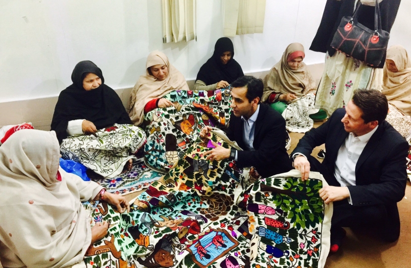 Nigel and Rehman Chishi meeting women at a refugee camp